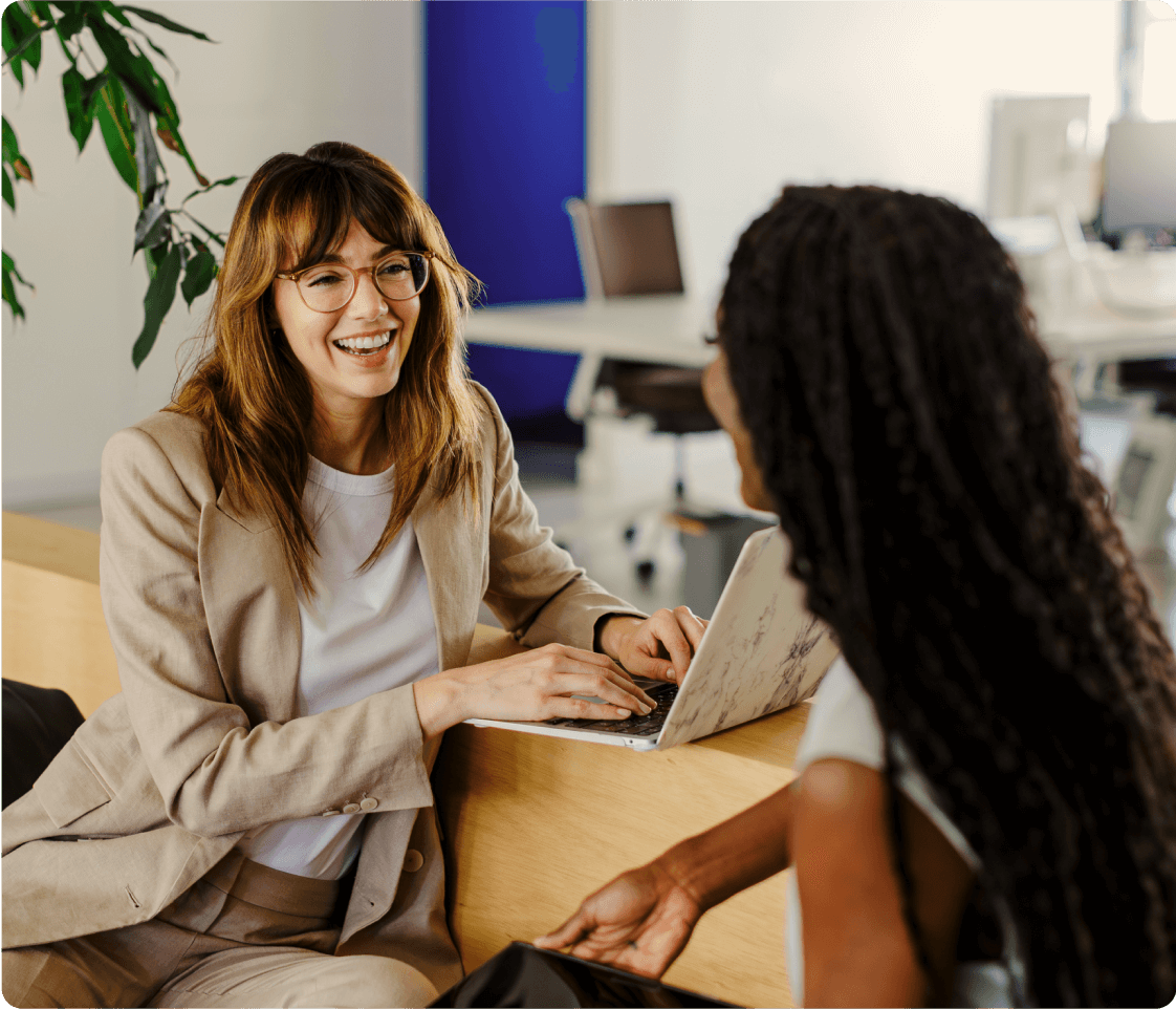 An advisor on a laptop talking to a client